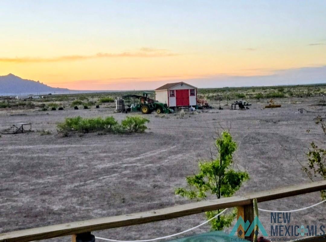 14006 Ciguena Road Southwest Deming, NM 88030 - Photo 19 of 49 Expansive undeveloped land featuring a detached shed with a red door and white siding