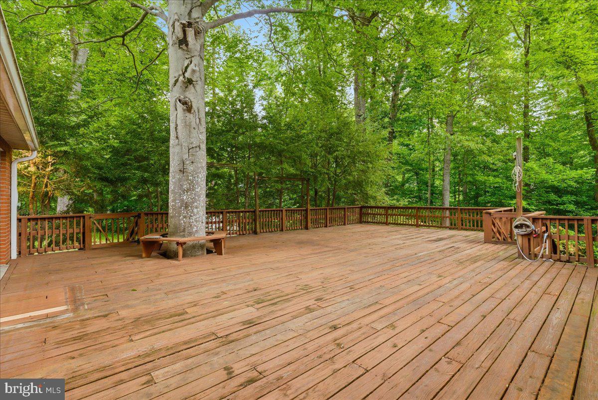 18309 Cabin Road Triangle, VA 22172 - Photo 21 of 42 a view of a deck with chairs a barbeque with wooden floor and fence