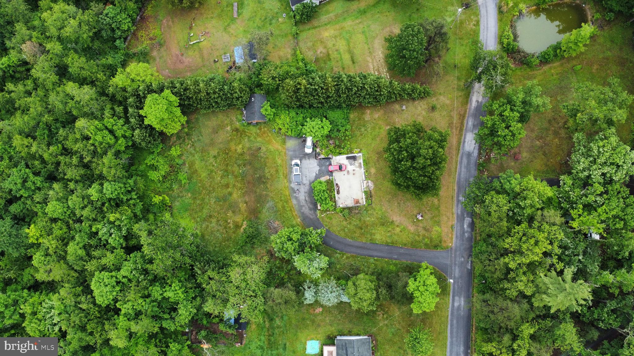 71 County Rte 9/11 Berkeley Springs, WV 25411 - Photo 3 of 9 Serene retreat amidst lush greenery.