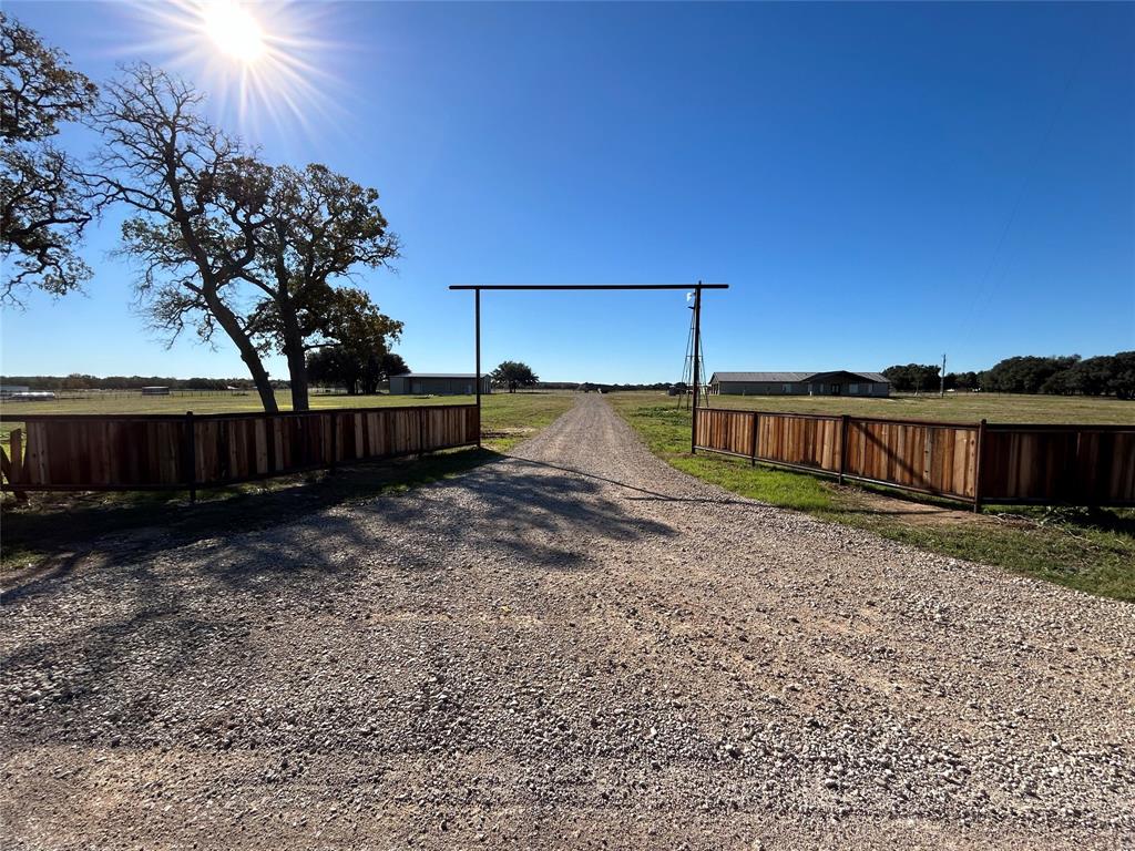 8740 Star Hollow Road Lipan, TX 76462 - Photo 1 of 40 a view of a backyard with wooden fence
