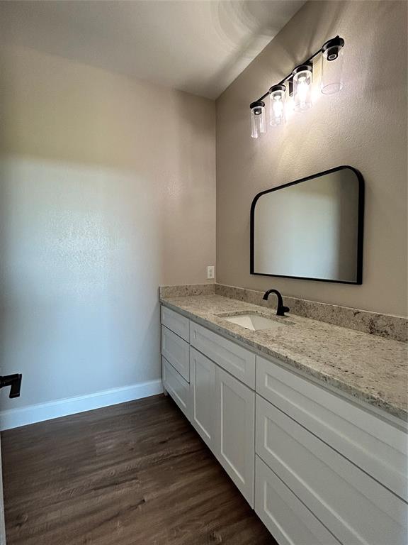 8740 Star Hollow Road Lipan, TX 76462 - Photo 15 of 40 a bathroom with a granite countertop sink and a mirror