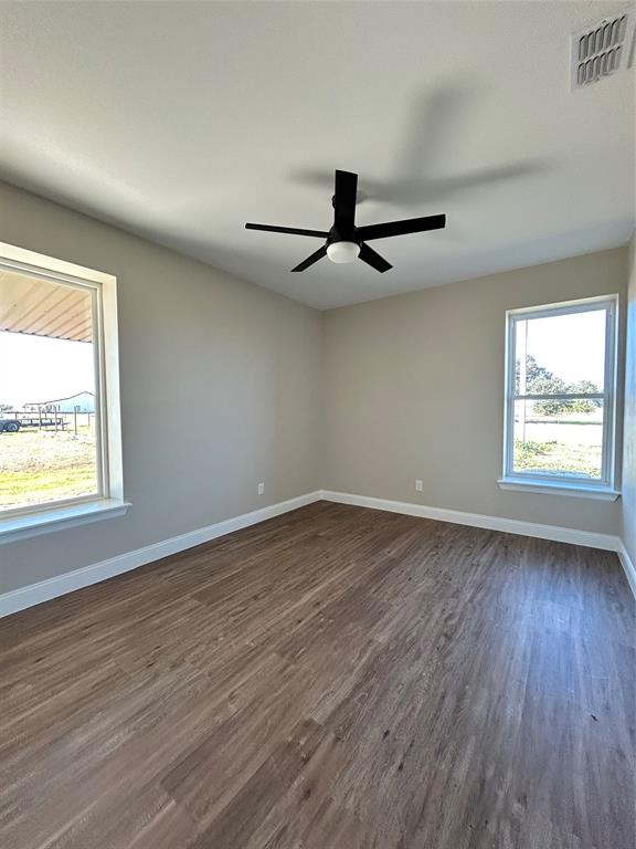 8740 Star Hollow Road Lipan, TX 76462 - Photo 16 of 40 a view of an empty room with wooden floor and a window