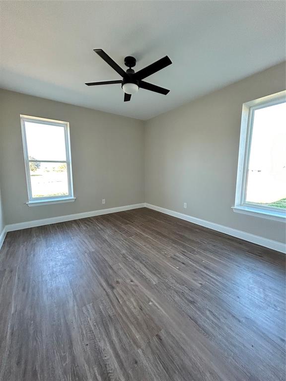 8740 Star Hollow Road Lipan, TX 76462 - Photo 18 of 40 wooden floor in an empty room with a window