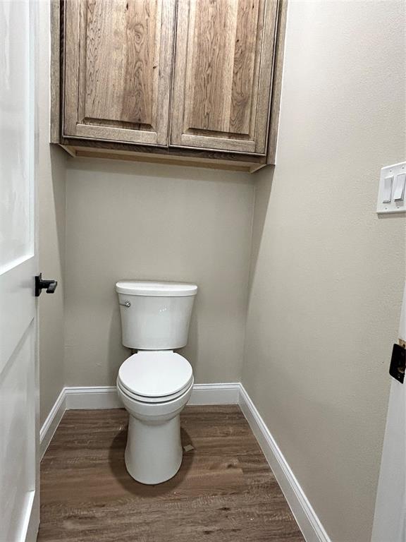 8740 Star Hollow Road Lipan, TX 76462 - Photo 23 of 40 a bathroom with a toilet and a sink