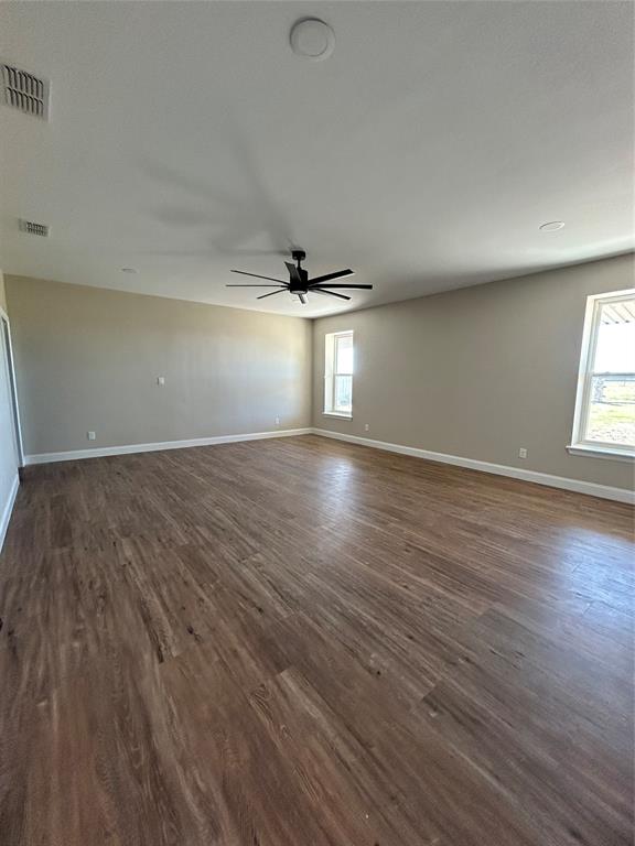 8740 Star Hollow Road Lipan, TX 76462 - Photo 26 of 40 an empty room with wooden floor and windows