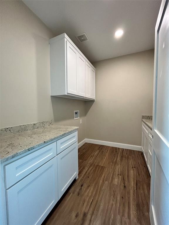 8740 Star Hollow Road Lipan, TX 76462 - Photo 30 of 40 a view of kitchen with granite countertop cabinets and wooden floor