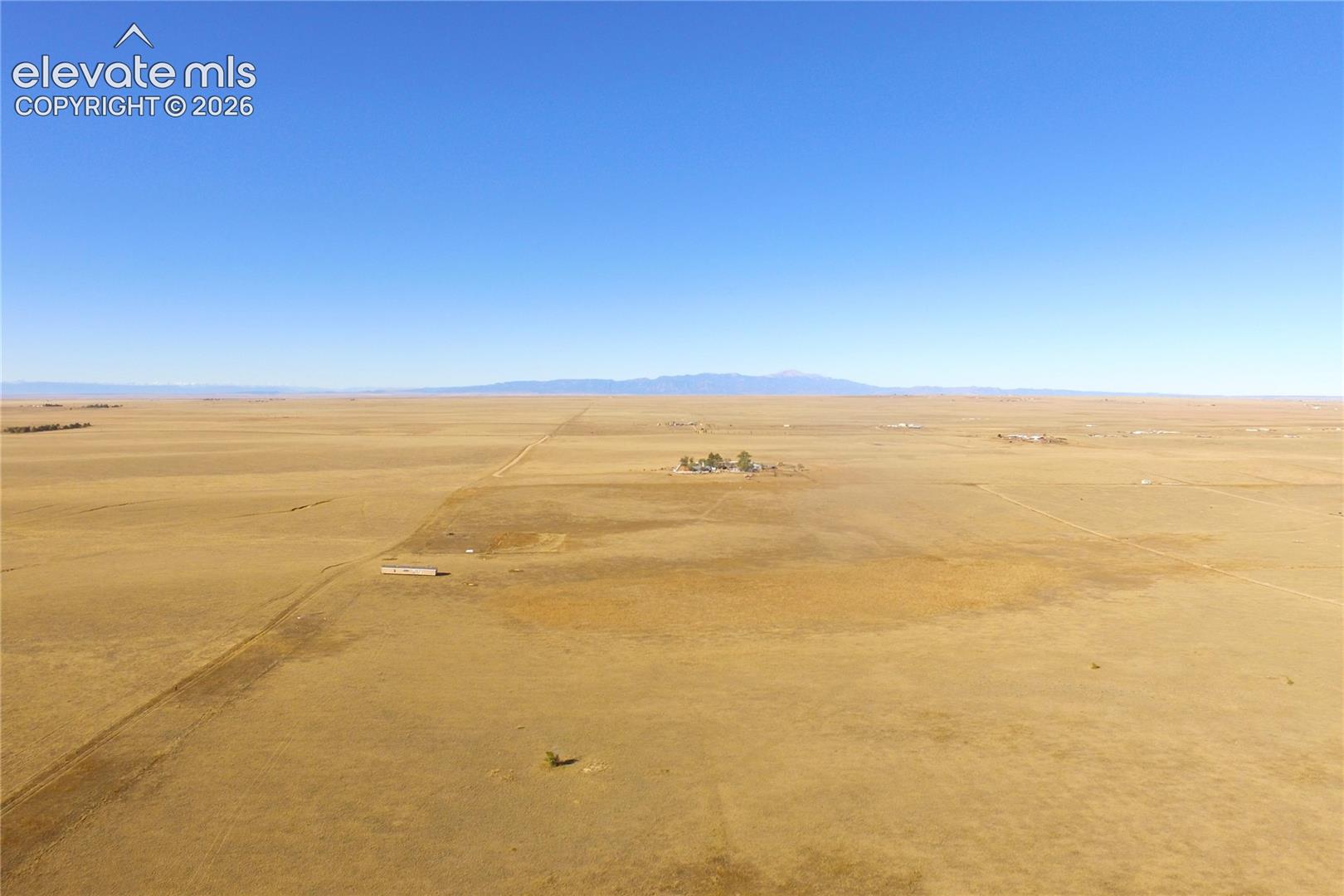 View of rural area featuring a desert landscape and a mountainous background