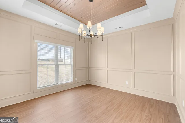 a view of a livingroom with a white ceiling fan and window