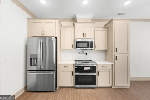 a kitchen with stainless steel appliances a refrigerator stove and sink