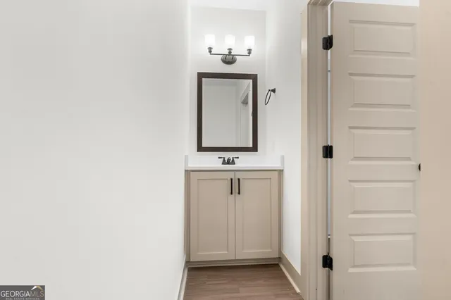 a bathroom with a sink a mirror and shower