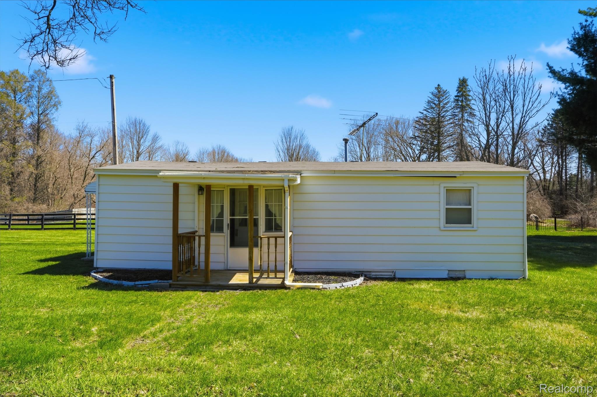 8636 Tindall Road Davisburg, MI 48350 - Photo 47 of 61 Rear view of house with a lawn