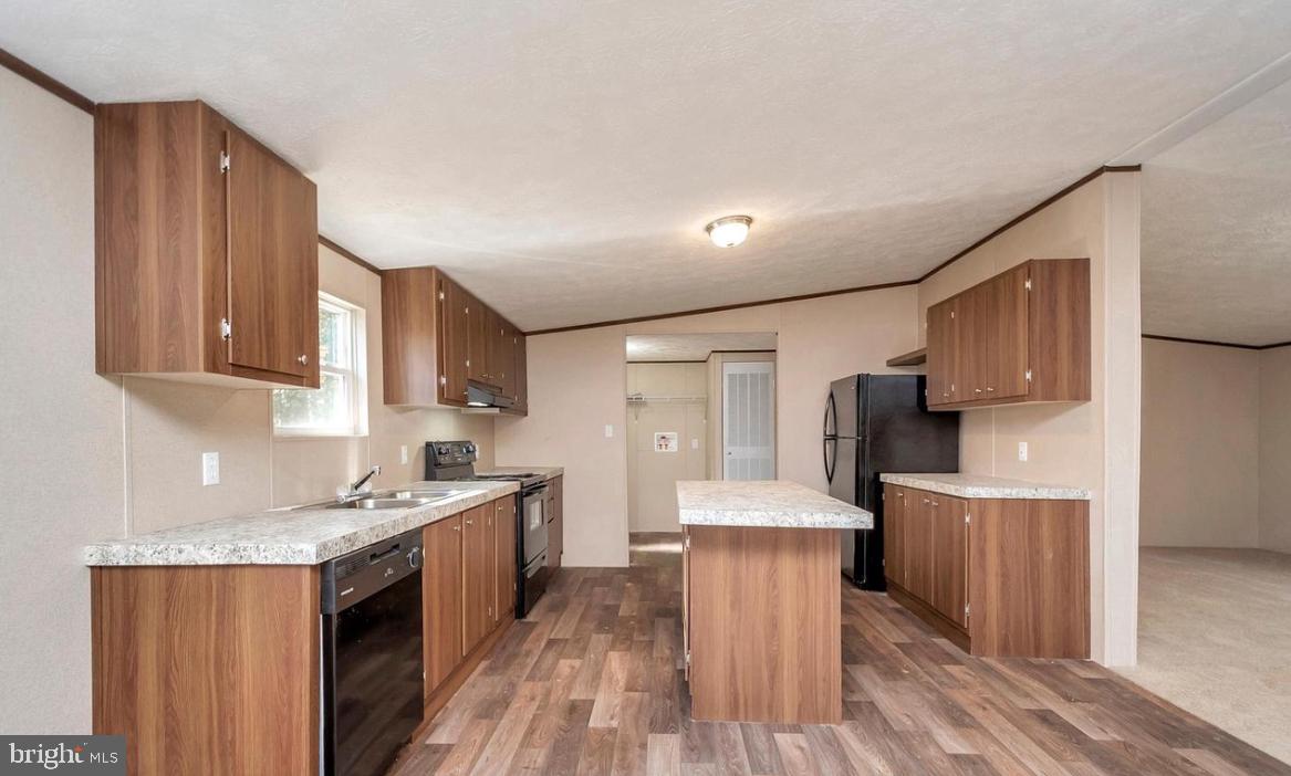 8510 Darcy Lane Partlow, VA 22534 - Photo 15 of 27 a kitchen with stainless steel appliances granite countertop a stove top oven a refrigerator a sink dishwasher and wooden cabinets with wooden floor