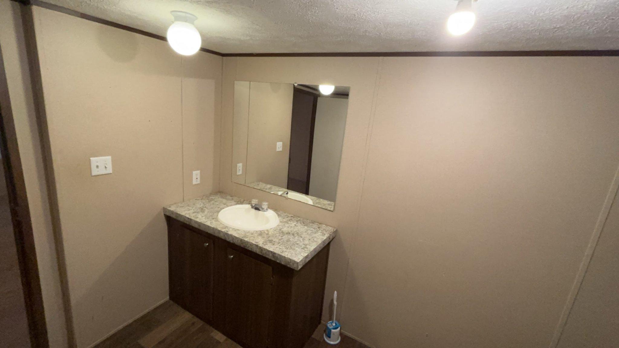 8510 Darcy Lane Partlow, VA 22534 - Photo 17 of 27 a bathroom with a granite countertop sink and a mirror