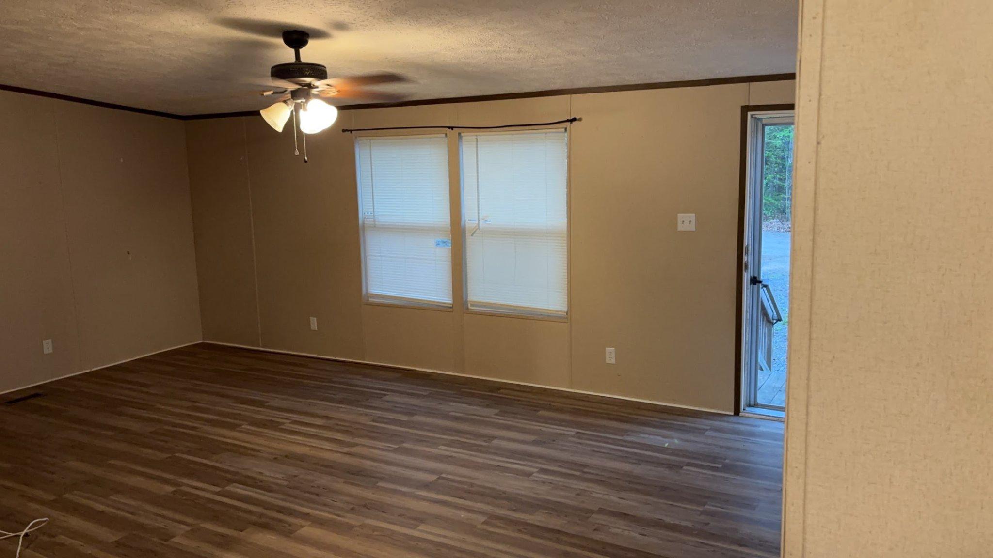 8510 Darcy Lane Partlow, VA 22534 - Photo 10 of 27 a view of an empty room with wooden floor and a window