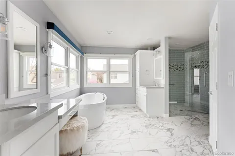 a spacious bathroom with a bathtub sink and mirror