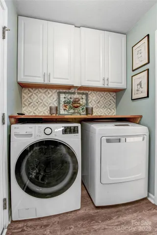 a utility room with granite countertop a washer and dryer