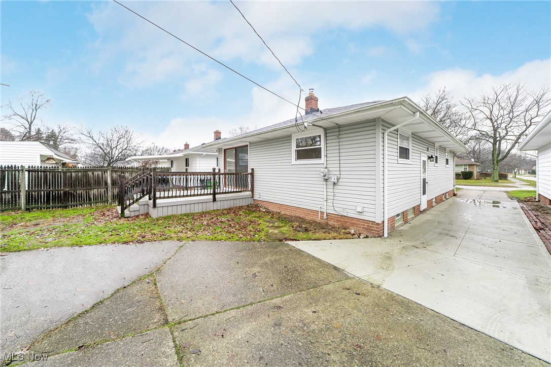 1122 Homestead Road Cleveland, OH 44121 - Photo 27 of 27 Back of property with a deck, concrete driveway, and a fence