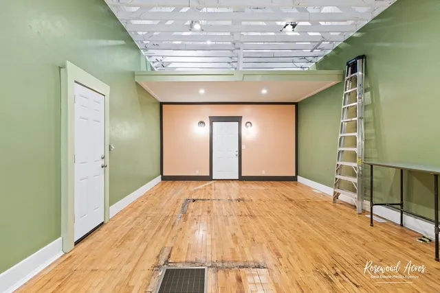 a view of a livingroom with an empty space and wooden floor