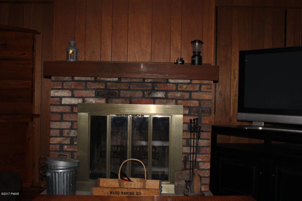 131 Maple Ridge Drive Hawley, PA 18428 - Photo 13 of 34 a kitchen with a refrigerator and cabinets