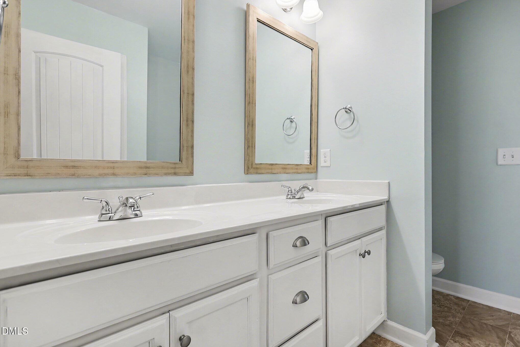 4818 Landover Bluff Way Raleigh, NC 27616 - Photo 19 of 30 a bathroom with a sink and a mirror
