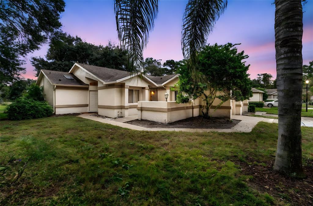 a front view of a house with a garden