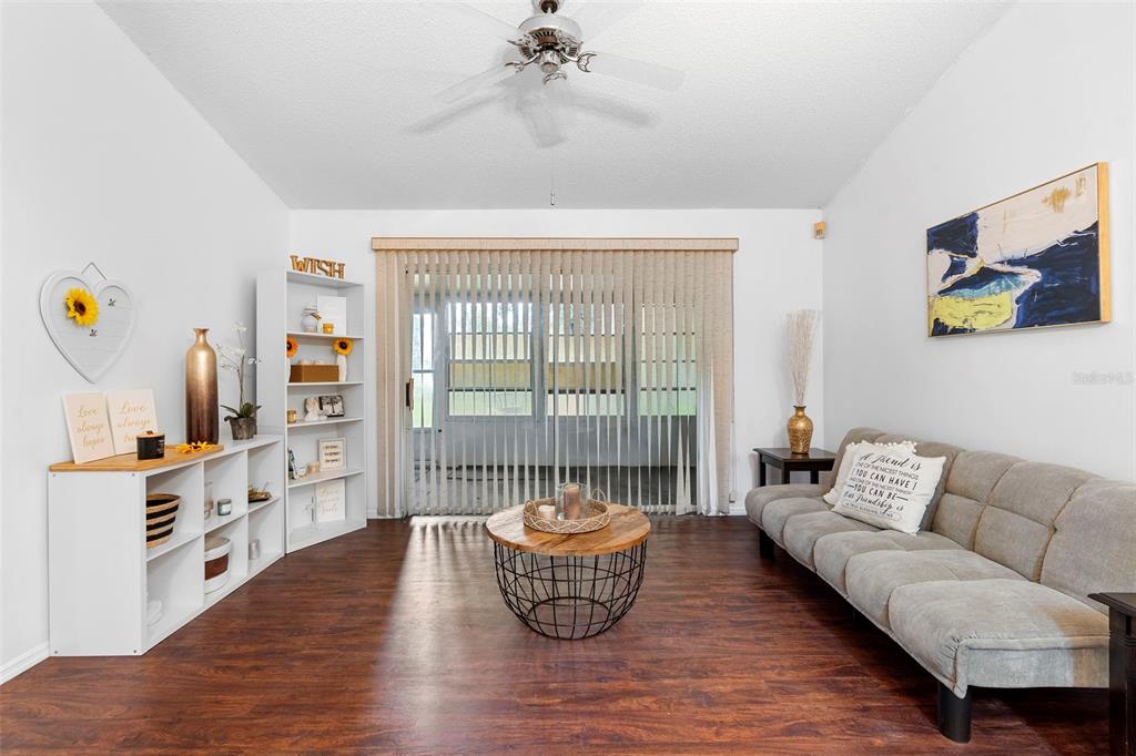 13103 Edberg Court Orlando, FL 32824 - Photo 14 of 42 a living room with furniture and a wooden floor