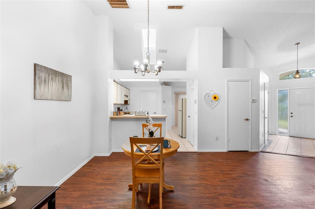13103 Edberg Court Orlando, FL 32824 - Photo 16 of 42 a view of a dining room with furniture and wooden floor