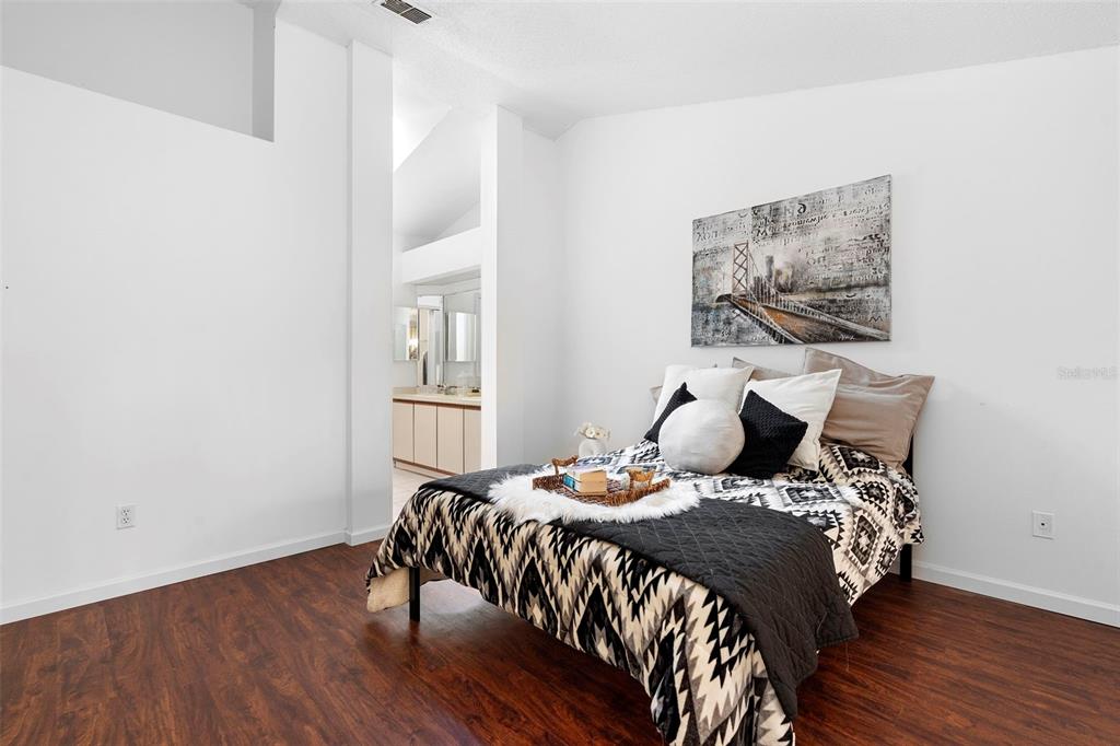 13103 Edberg Court Orlando, FL 32824 - Photo 26 of 42 a bedroom with a bed and wooden floor