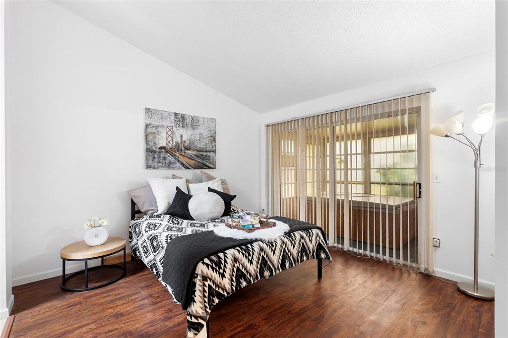 13103 Edberg Court Orlando, FL 32824 - Photo 27 of 42 a bedroom with a bed and wooden floor