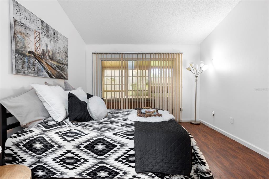 13103 Edberg Court Orlando, FL 32824 - Photo 28 of 42 a bedroom with a bed and wooden floor