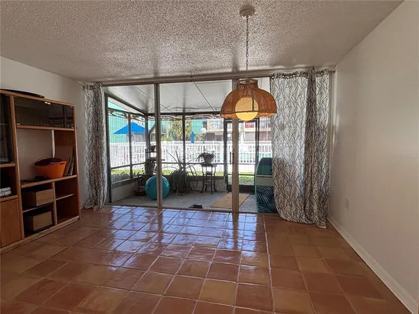 a view of an empty room with a birdcage and a window