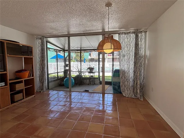 a view of an empty room with a birdcage and a window