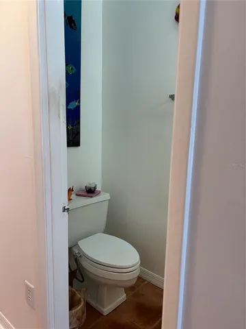 a white toilet sitting next to a shower