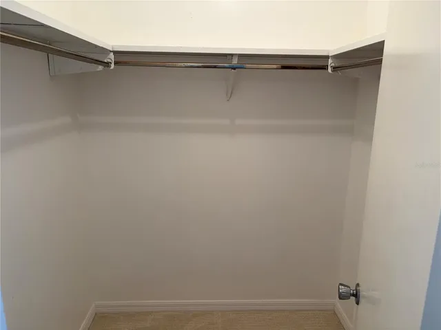 a view of a room that has a bed and a window