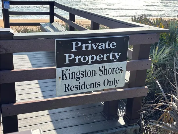 a view of a room with wooden floor and a rug