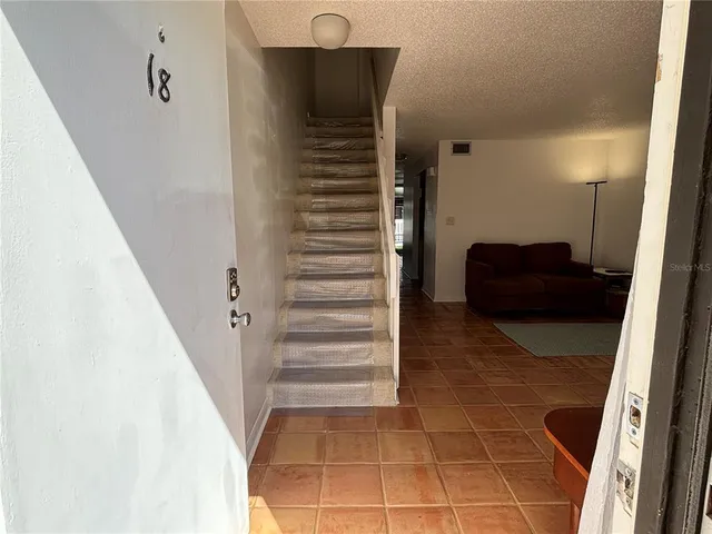 a living room with furniture and a ceiling fan