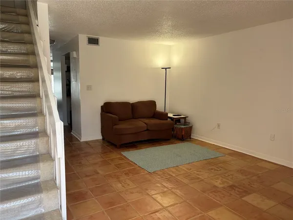 a living room with furniture and a lamp