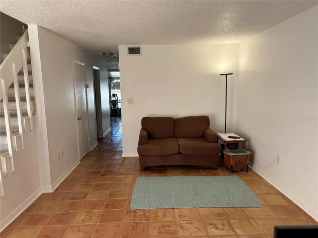 a view of a livingroom with furniture and a flat screen tv