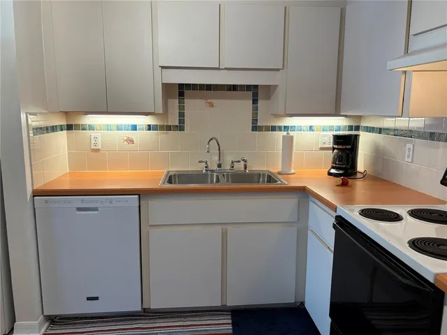 a kitchen with stainless steel appliances a stove a sink and a refrigerator