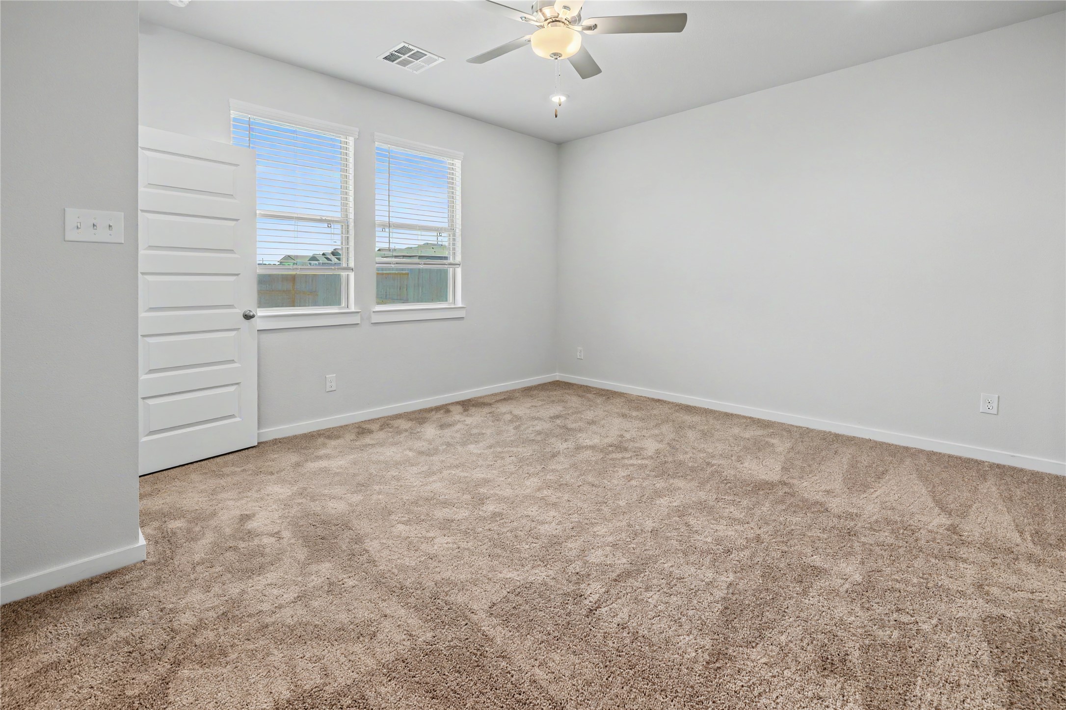 6423 Bolinas Court Rosharon, TX 77583 - Photo 20 of 39 an empty room with windows and fan