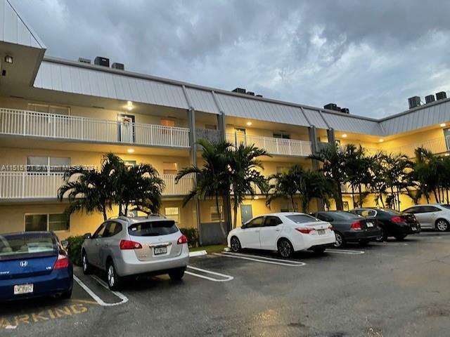 2960 Riverside Drive, Unit 3192 Coral Springs, FL 33065 - Photo 11 of 12 a view of a cars park in front of a building