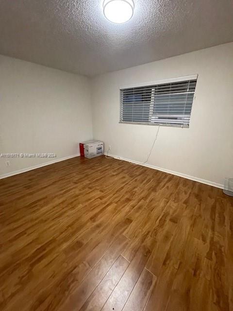 2960 Riverside Drive, Unit 3192 Coral Springs, FL 33065 - Photo 6 of 12 a view of an empty room with wooden floor and a window