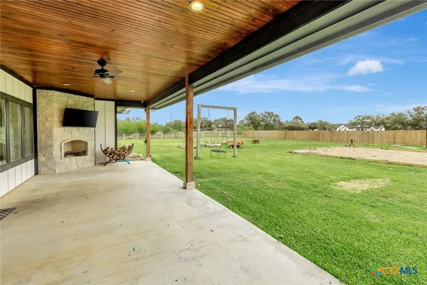 a view of a porch with furniture and garden