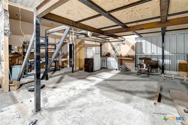 a view of a garage with storage and utility