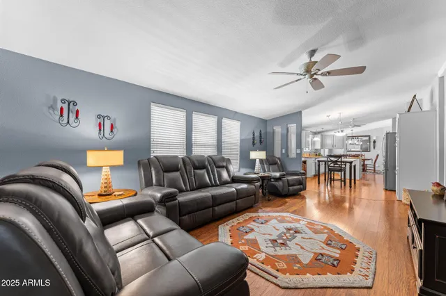 a living room with furniture and a view of kitchen