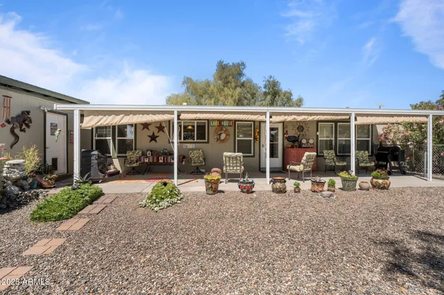a view of a house with backyard sitting area and garden