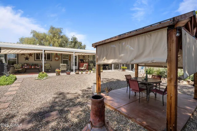 a view of a patio with table and chairs and potted plants
