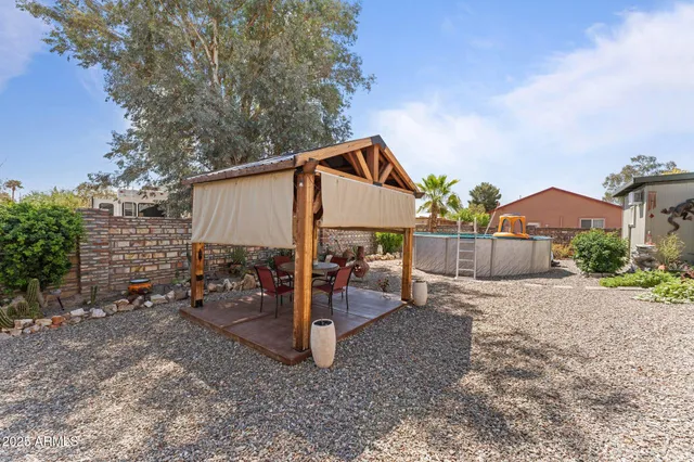 a view of a house with a yard and sitting area