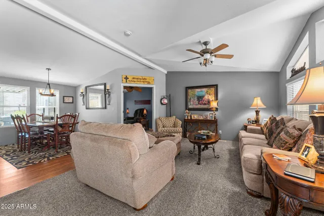 a living room with furniture a fireplace and a large window