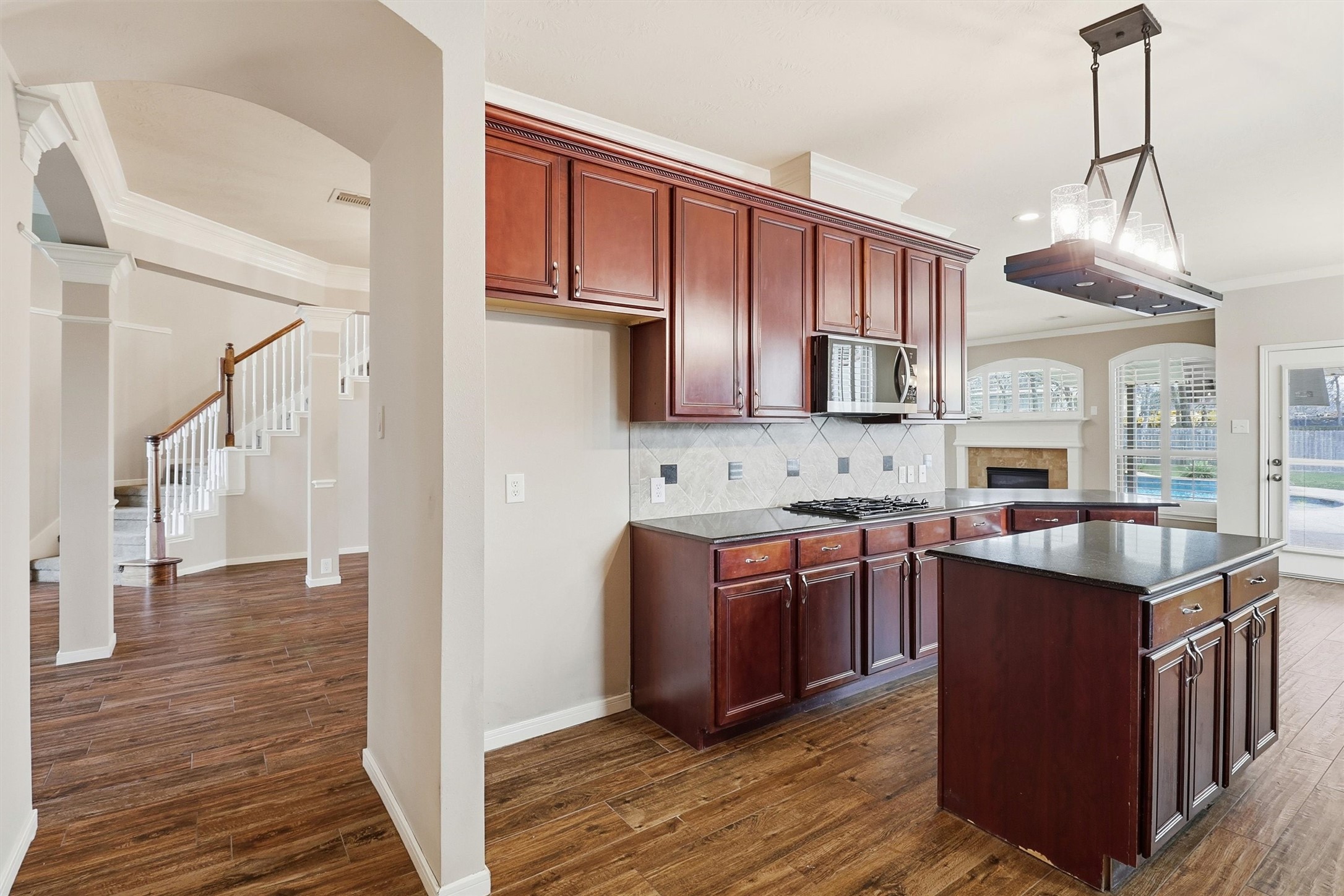 3602 River Bend Drive Rosenberg, TX 77471 - Photo 19 of 49 a kitchen with stainless steel appliances granite countertop a stove a sink dishwasher a refrigerator and a oven with wooden floor